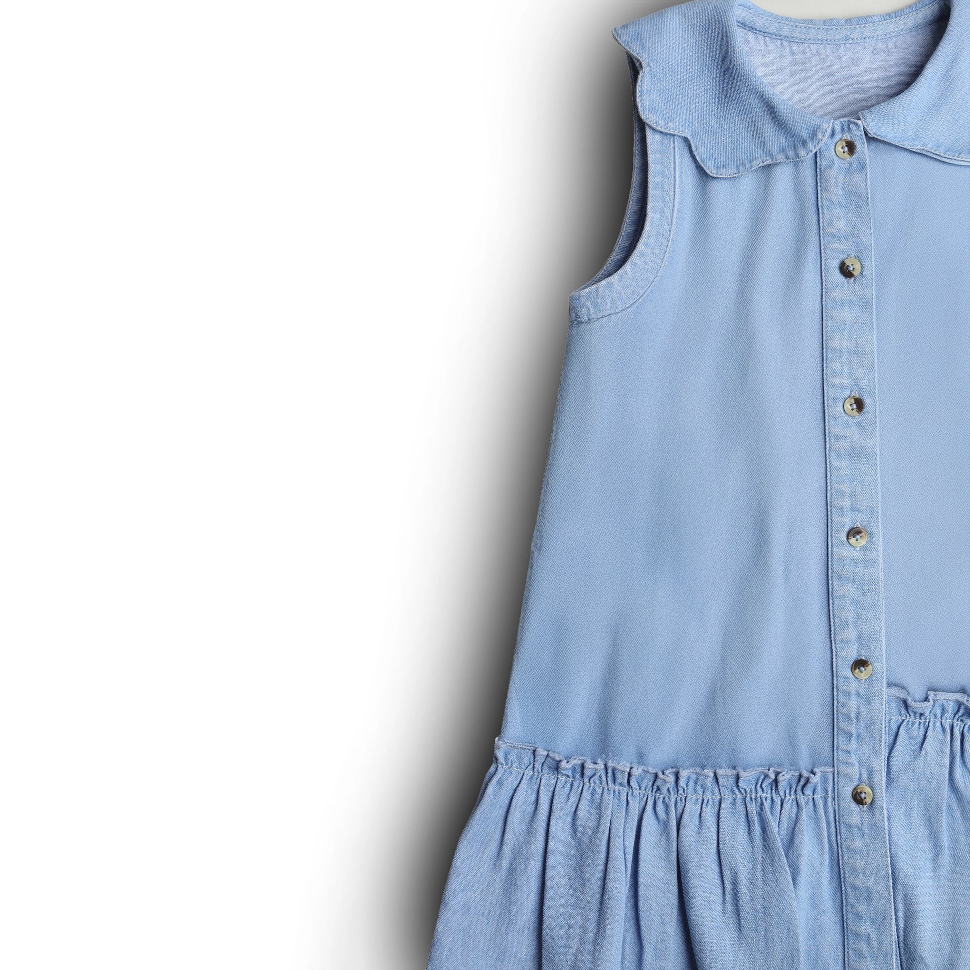 Light blue dress with collar and buttons on a white background